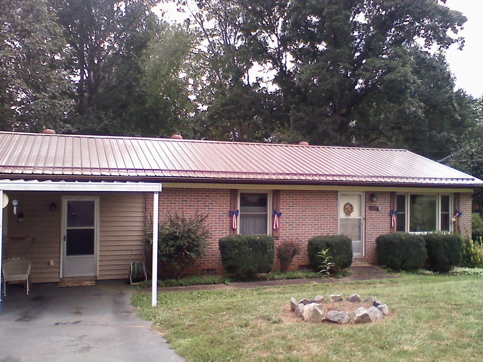 Bronze metal roof and carport on a brick ranch home — Roof Repair work by our crew in Glendale Heights