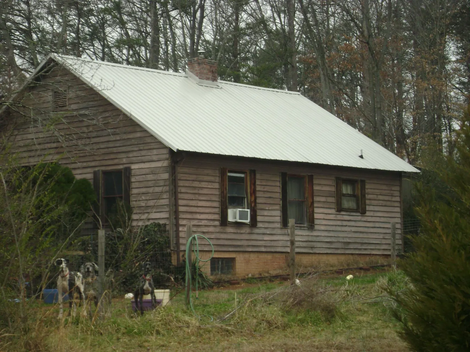 White metal roof on an old wood sided farmhouse, from a Metal Roof Installation job in Glendale Heights